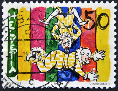 SWITZERLAND - CIRCA 1992: A stamp printed in Switzerland shows a trapeze clown, circa 1992 のeditorial素材
