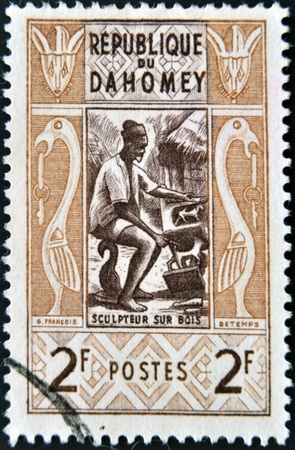 DAHOMEY CIRCA 1961: stamp printed in Dahomey shows Wood sculptor, circa 1961 のeditorial素材
