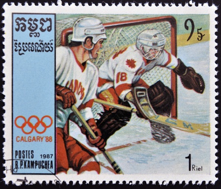 CAMBODIA - CIRCA 1987: A stamp printed in Cambodia shows Canadian team players, ice hockey, circa 1987 のeditorial素材