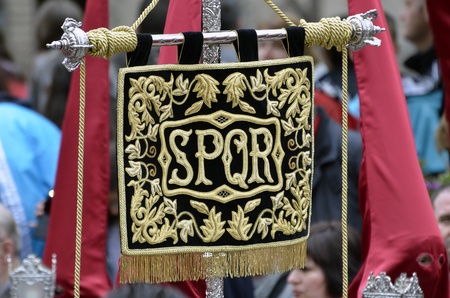 GRANADA, ANDALUSIA, SPAIN - APRIL 6:Banner with the letters SPQR (Senatvs Popvlvsqve Romanvs) in typical procession of Holy Week in April 6, 2012 in Granada, Andalusia, Spain のeditorial素材