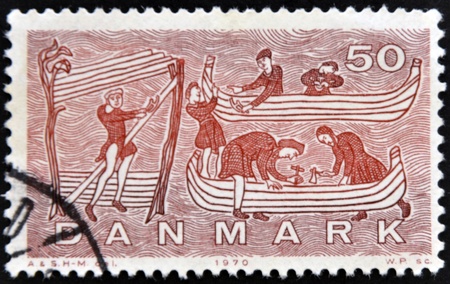 DENMARK - CIRCA 1970: A stamp printed in Denmark shows construction of a Viking ship, circa 1970の写真素材