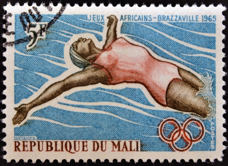 MALI - CIRCA 1965: stamp printed in Mali shows Swimmer, circa 1965 の写真素材