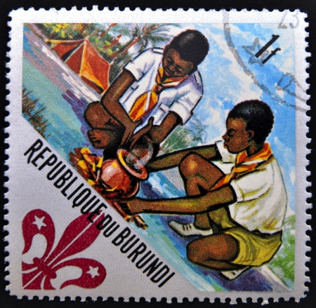 BURUNDI - CIRCA 1967: A stamp printed in Burundi shows Scouts preparing meal, circa 1967のeditorial素材
