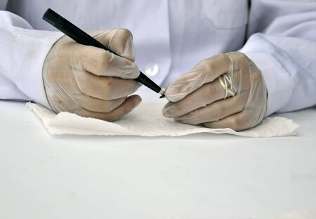 woman restoring ancient coinsの写真素材