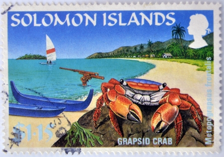 SOLOMON ISLANDS - CIRCA 2000: A stamp printed in Solomon islands shows a grapsid crab on a beach paradise, circa 2000の写真素材
