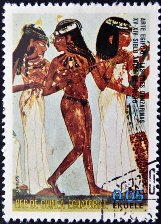 EQUATORIAL GUINEA - CIRCA 1974: A stamp printed in Equatorial Guinea dedicated to the female nude in art history shows The three dancers of Egyptian art, circa 1974 の写真素材