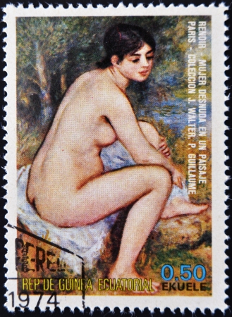 EQUATORIAL GUINEA - CIRCA 1974: A stamp printed in Equatorial Guinea dedicated to the female nude in art history shows naked woman in a landscape by Renoir, circa 1974 のeditorial素材