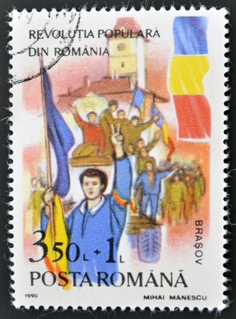 ROMANIA - CIRCA 1990: stamp printed in Romania shows Soldiers and crowd, popular revolution, circa 1990の写真素材