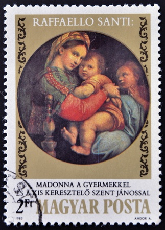 HUNGARY - CIRCA 1983: stamp printed in Hungary,  shows la Vierge a la chaise  by Raphael on the 500th anniversary of his birthday, circa 1983のeditorial素材