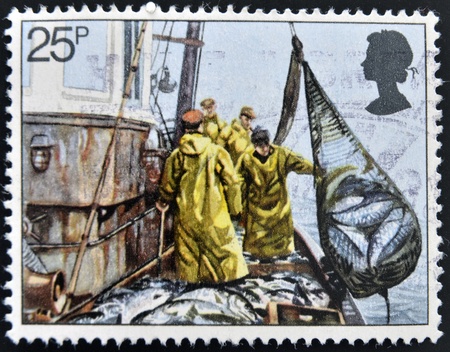 UNITED KINGDOM - CIRCA 1981: A stamp printed in Great Britain shows Hoisting Seine Net, fishing, circa 1981の写真素材