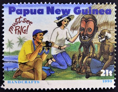 PAPUA NEW GUINEA - CIRCA 1995: A stamp printed in Papua dedicated to tourism shows handcrafts, circa 1995のeditorial素材