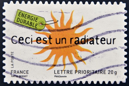 FRANCE - CIRCA 2008  A stamp printed in France dedicated to sustainable ideas, shows sun, This is a radiator, circa 2008 のeditorial素材