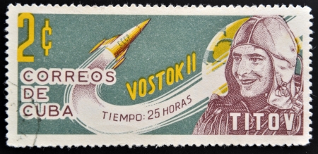 CUBA - CIRCA 1963: A stamp printed in Cuba shows Titov and rocket Vostok 2, circa 1963 のeditorial素材