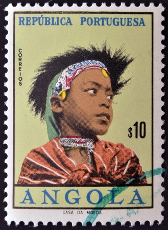 ANGOLA - CIRCA 1961: A stamp printed in Angola shows portrait of a child Angolan traditional clothes , circa 1961. のeditorial素材
