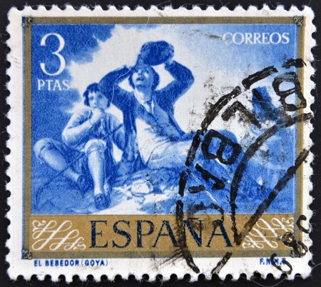 SPAIN - CIRCA 1958: A stamp printed in Spain shows paintings The Drinker by Francisco de Goya, circa 1958のeditorial素材