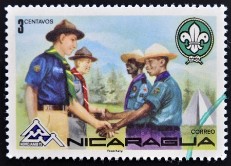 NICARAGUA - CIRCA 1975: A stamp printed in Nicaragua shows meeting between boy scout groups, circa 1975 のeditorial素材