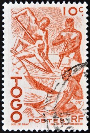TOGO - CIRCA 1950: stamp printed in France shows four natives at work, Togo, circa 1950. の写真素材