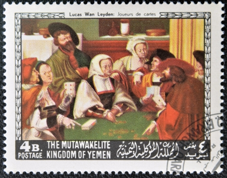 YEMEN - CIRCA 1968: A stamp printed in Yemen shows The Card Players by Lucas van Leyden, circa 1968 の写真素材