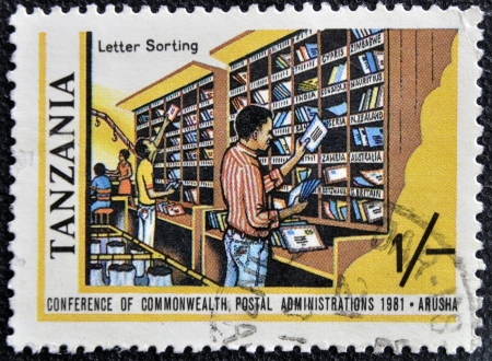 TANZANIA - CIRCA 1981: A stamp printed in Tanzania shows letter sorting, circa 1981のeditorial素材