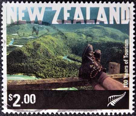 NEW ZEALAND - CIRCA 2001: A stamp printed in New Zeland shows Tramping,  Fiordland National Park, circa 2001の写真素材