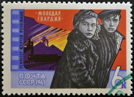 USSR - CIRCA 1965: A stamp printed in USSR shows Scene from movie âYoung Guardâ with inscription "Young Guard, Director S. Gerasimovâ, circa 1965 のeditorial素材