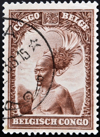 BELGIAN CONGO - CIRCA 1942: A stamp printed in Belgian Congo shows Head of a native men, circa 1942 の写真素材