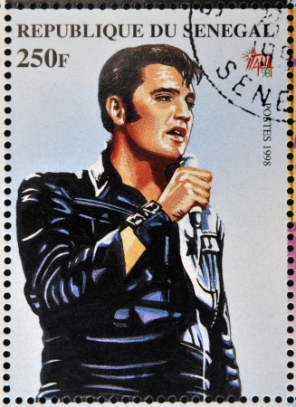 SENEGAL - CIRCA 1998: A stamp printed in Senegal shows the famous Elvis Presley, circa 1998 のeditorial素材