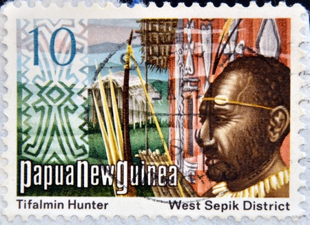 PAPUA NEW GUINEA - CIRCA 1980: A stamp printed in Papua shows Tifalmin Hunter and West Spok District, circa 1980のeditorial素材
