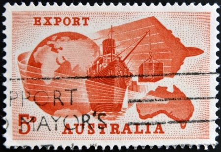 AUSTRALIA - CIRCA 1963  A stamp printed in Australia dedicated to Importance of exports to Australian economy shows Globe, Ship, Plane and Map of Australia, circa 1963 の写真素材