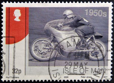 ISLE OF MAN - CIRCA 2009: A stamp printed in Isle of Man dedicated to racing motorcycles of the 50, circa 2009 のeditorial素材