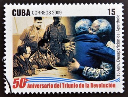 CUBA - CIRCA 2009: A stamp printed in cuba dedicated to 50 anniversary of the triumph of the revolution, shows anniversary of the demise of apartheid, embrace between Fidel and Mandela, circa 2009 のeditorial素材