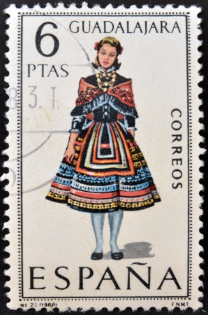 SPAIN - CIRCA 1968: A stamp printed in Spain dedicated to Provincial Costumes shows a woman from Guadalajara, circa 1968の写真素材