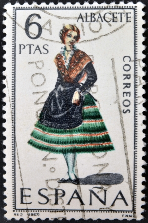 SPAIN - CIRCA 1967: A stamp printed in Spain dedicated to Provincial Costumes shows a woman from Albacete, circa 1967の写真素材