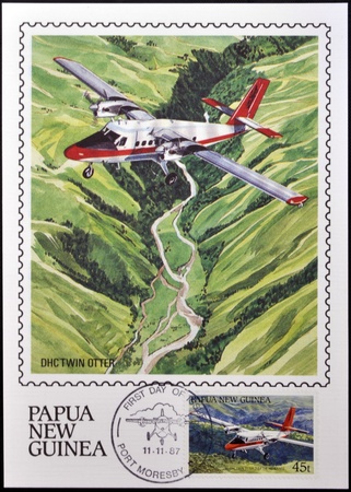 PAPUA NEW GUINEA - CIRCA 1987: A stamp printed in Papua shows A DHC Twin Otter in flight over of highlands of Papua New Guinea, circa 1987のeditorial素材