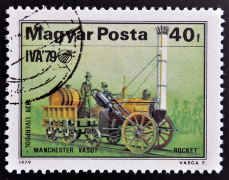 HUNGARY - CIRCA 1979: A stamp printed in Hungary shows emblem of International Transport Exhibition and Stephenson "Rocket", 1829, circa 1979 のeditorial素材