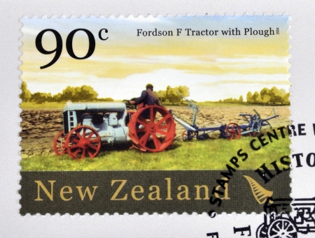 NEW ZEALAND - CIRCA 2004  A stamp printed in New Zealand dedicated to historic farm equipment, shows Fordson F tractor with Plough, circa 2004のeditorial素材