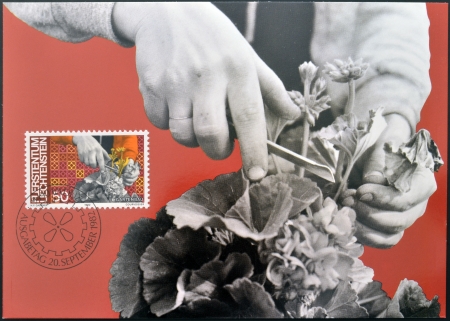 LIECHTENSTEIN - CIRCA 1982: A stamp printed in Liechtenstein dedicated to Man and work shows horticulture, circa 1982 のeditorial素材
