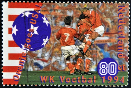 HOLLAND - CIRCA 1994: A stamp printed in Netherlands commemorating oranje goes USA, circa 1994 のeditorial素材