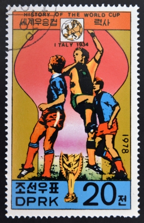 KOREA - CIRCA 1978: A Stamp printed in North Korea shows the Soccer players, Cup and Glob with the inscription "Italy, 1934", from the series "History of World Cup Football Championship", circa 1978 のeditorial素材