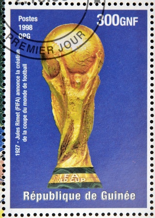 GUINEA - CIRCA 1998: a stamp printed in Republic of Guinea commemorating Jules Rimet (FIFA) announced the creation of the football world cup, circa 1998.のeditorial素材
