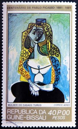 GUINEA - CIRCA 1981: A stamp printed in Republic of Guinea Bissau shows Jacqueline in turkish costume by Pablo Picasso, circa 1981のeditorial素材