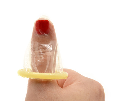 Hand with condom isolated on white の写真素材