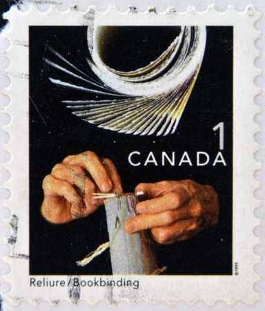 CANADA - CIRCA 1999: A stamp printed in Canada, shows bookbinging, circa 1999 の写真素材