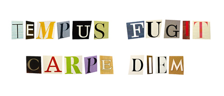 The phrase Tempus Fugit, Carpe Diem formed with magazine letters on white backgroundの写真素材