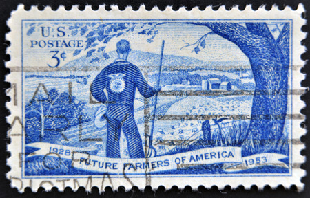 UNITED STATES OF AMERICA - CIRCA 1953: A stamp printed in USA shows young man with emblem of usa stamp Future farmers of America organisation,, circa 1953 のeditorial素材