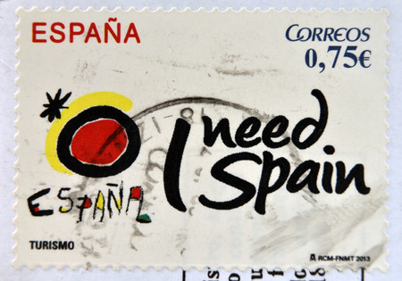SPAIN - CIRCA 2013: A stamp printed in spain shows Spanish tourism symbol created by Joan Miro, I need spain, circa 2013の写真素材