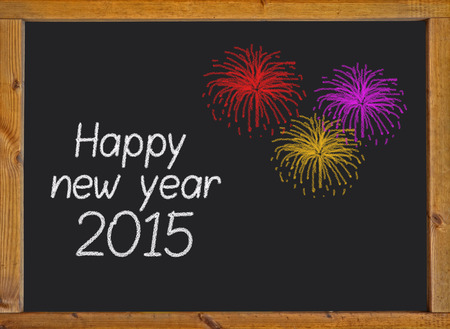 Happy new year 2015 written on a small blackboard with a wooden frame