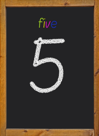 5 written on a black blackboardの写真素材