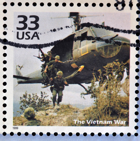 UNITED STATES OF AMERICA - CIRCA 1999: Stamp printed in USA dedicated to celebrate the century 1960s, shows the vietnam war, circa 1999のeditorial素材