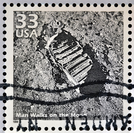 UNITED STATES OF AMERICA - CIRCA 1999: Stamp printed in USA dedicated to celebrate the century 1960s, shows man walks on the moon, circa 1999のeditorial素材